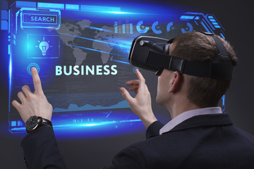 Business, Technology, Internet and network concept. Young businessman working on a virtual screen of the future and sees the inscription: Business