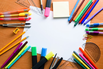 Fototapeta premium Mock up. Creative space. Artistic work tools on light wooden table: Colored pencils, pens, markers.