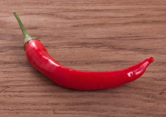 Hot red chili or chili pepper on wooden background.