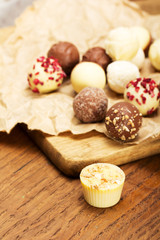 Selection of delicious chocolates on a rustic background