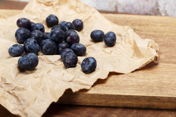 Fresh blueberries on a rustic brown paper background
