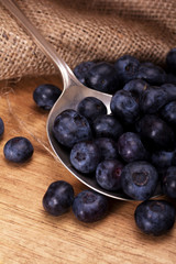 Blueberries and spoon on a rustic background