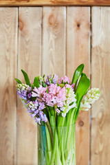 Spring background with hyacinths. Background with spring flowers. Bouquet of hyacinths on a wooden background