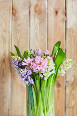 Spring background with hyacinths. Background with spring flowers. Bouquet of hyacinths on a wooden background