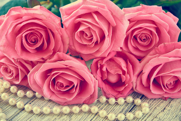 Beautiful pink rose on a wooden background