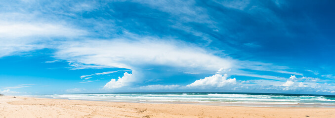 The panoramic view of the ocean beach with beautiful bright cloudy sky in Gold Coast, Australia