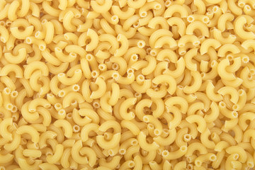 Full background of dry uncooked macaroni pasta