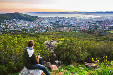 Naklejka na ściany i meble Tourist enjoying view of Cape Town after morning walk