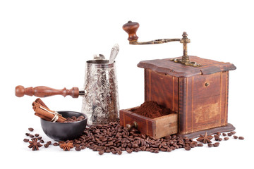Old coffee grinder maker and coffee beans.