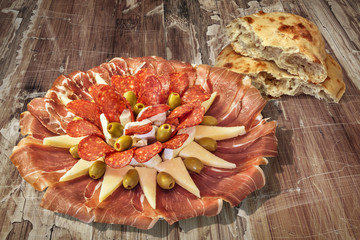 Appetizer Savory Dish Meze and Torn Pitta Bread Loaf Halves Set on Old Weathered Cracked Wooden Garden Table