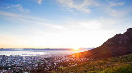 Beautiful view of sunrise behind Cape Town mountains and city
