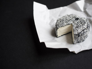 French goat cheese, Cabrissac from Loire, on dark background