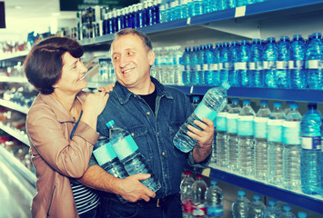 Portrait of couple buying a water