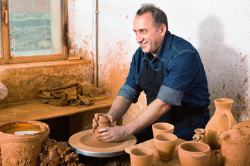 Elderly master among the pottery