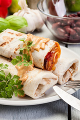 Mexican burritos wraps with mincemeat, beans and vegetables