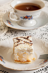 Fresh sweet apple cake with whipped cream served with cup of tea