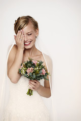 Laughing bride in white wedding dress