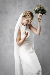 Successful and cheering bride in studio