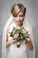 Bride holding flowers in wedding dress