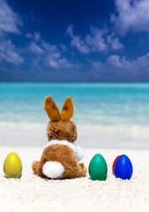 Osterhase und bunte Eier am Strand