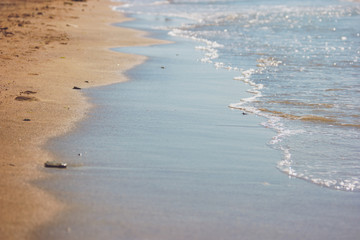 Water on a shore. Wet sand on a beach. Island amidst Caspian sea. Relax and forget all problems.