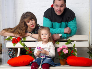 Happy family posing in an interior studio