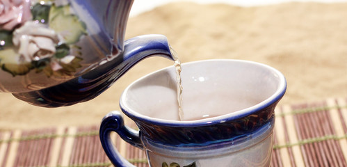 Pour tea into a cup of teapot