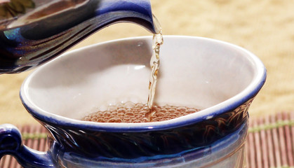 Pour tea into a cup of teapot