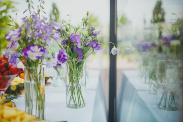 beautiful flowers in vases and decorations at the wedding