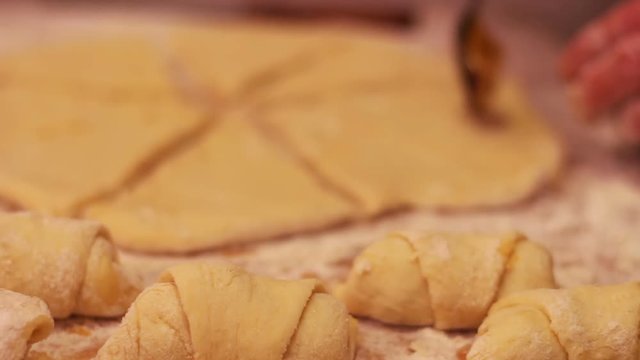 A woman puts on fresh pieces of dough apricot jam