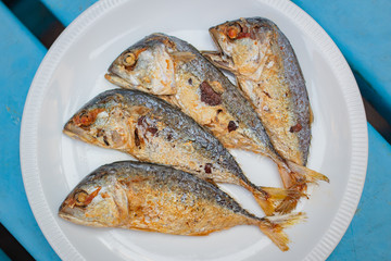 Fried mackerel in white plate.