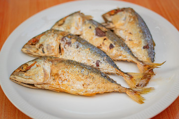 Fried mackerel in white plate.