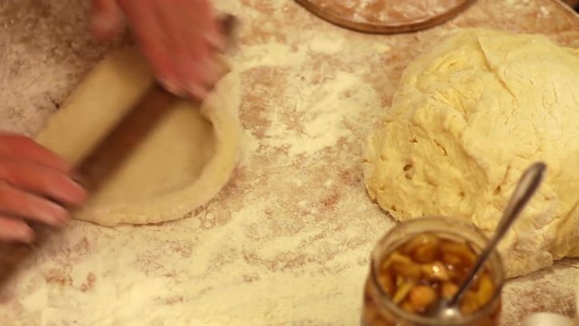 Woman working with dough. making homemade croissants