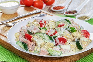 salad with meat, cucumber, tomato, cheese, omelette