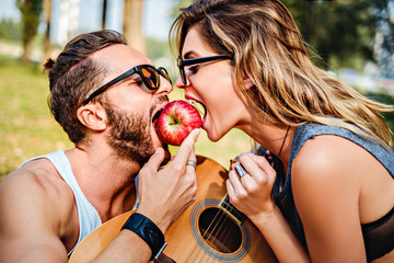 Couple eating apple together