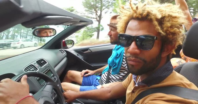 Black handsome men driving his friends in convertible