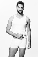 Fototapeta premium Underwear guy posing in shorts and vest, portrait