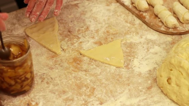 Woman working with dough. making homemade croissants