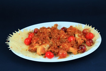 Baked chicken on white plate.