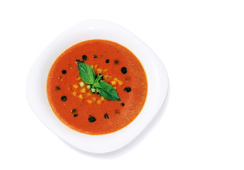 Gaspacho cold summer soup in porcelain plate, isolated on white background