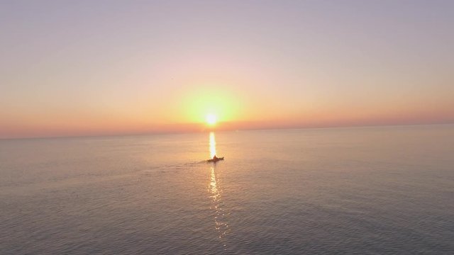 Ocean Sunrise Aerial with a small boat