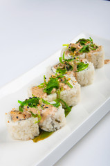 sushi roll with cream cheese, seaweed, sesame seeds, spicy sauce