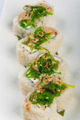 sushi roll with cream cheese, seaweed, sesame seeds, spicy sauce