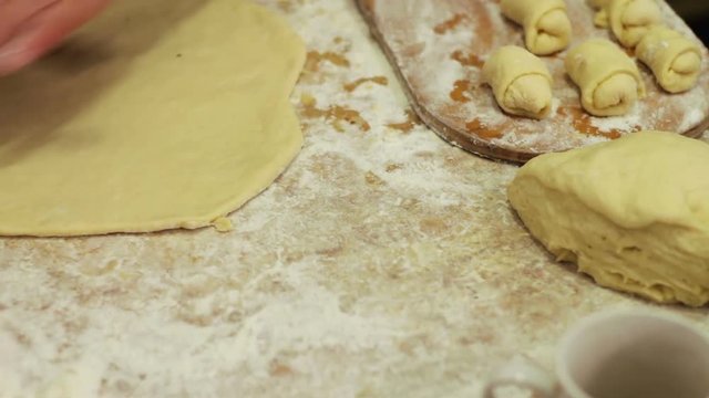 Woman working with dough. making homemade croissants