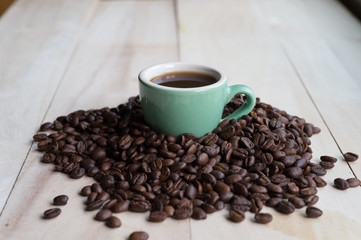 Coffee. Coffee beans. Coffee cup full of coffee beans. Toned image.