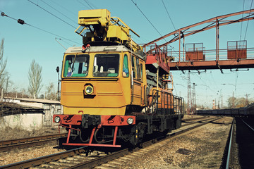 Fototapeta premium Yellow Railway track service car fixing the railroad.Toned image.
