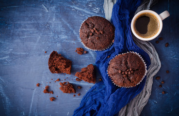 Chocolate cupcakes with a cup of hot black coffee. Selective focus. Top view