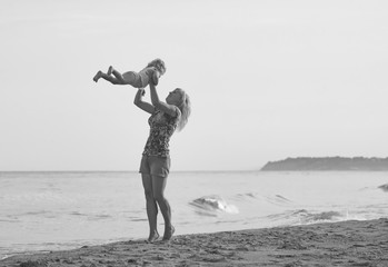 Mother playing with her daughter. Black and white