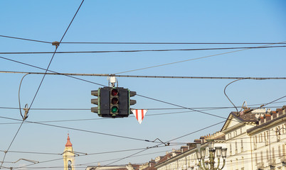 Red and green traffic lights against blue sky and cities backgrounds