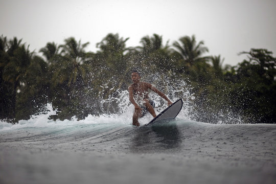 Indonesia, Java, surfer on a wave